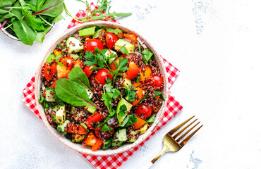 Quinoa vegan salad with avocado, tomatoes, onion and parsley, white background, top view