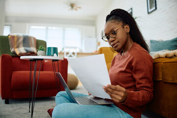 Young black woman studying online at home.