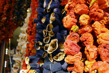 Bundles of dried vegetables at the old market in the gastronomic capital of Turkey - the city of Gaziantep. Dehydrated red peppers, eggplants and zucchini for sale at a Turkish bazaar.