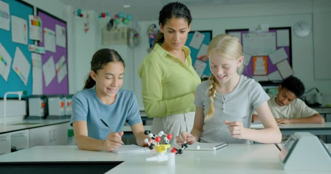 Two Girl Students in Science Class Looking at a Molecular model Together