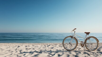 Fototapeta premium A pristine beach scene with a solitary bicycle parked on the sandy beach under a clear blue sky, representing solitude and the beauty of untouched nature.