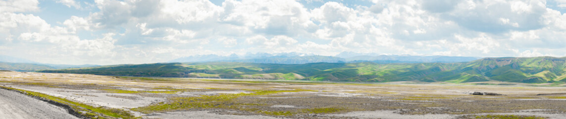 Panorama of southern Kyrgyzstan view of high mountain plateau on the road to Kelsuu lake.