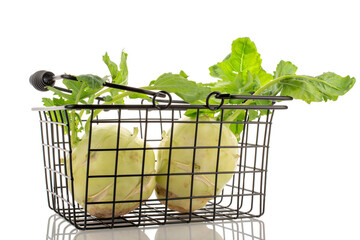 Two ripe kohlrabi in a basket, macro, isolated on white background.