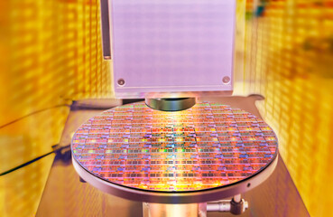 Silicon wafer with semiconductor microchip on machine process examining testing in microscope.