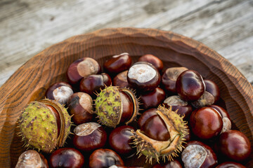 Chestnuts in a Wooden Bowl on a Wooden Table
