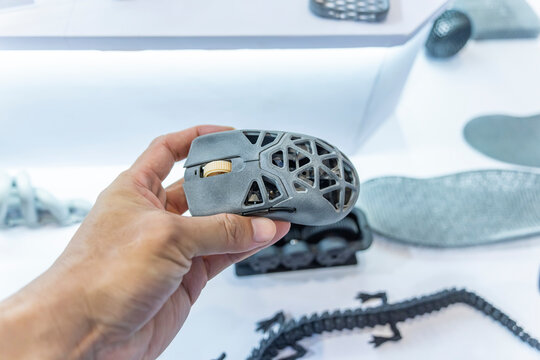 hand with hollow computer mouse object printed on 3d printer close-up