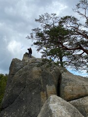 person near the cave in the mountains