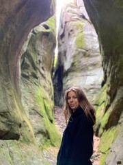 person near the cave in the mountains