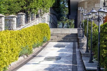 
a garden in a park with lanterns and stone-tiled steps