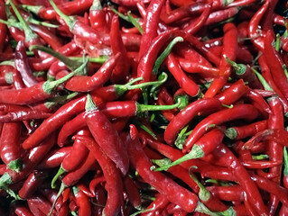Fresh red chilies displayed in a vegetable shop.