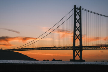 Obraz premium [HYOGO]Sunset view of Akashi Kaikyo Bridge, known as one of the world's largest suspension bridges, The orange sunset sky is beautiful, Azur Maiko, Japan