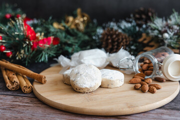 Baking polvorones traditional for Christmas season, or called nevaditos, mantecados or sweet cookies on plate for holidays. recipe and ingredients