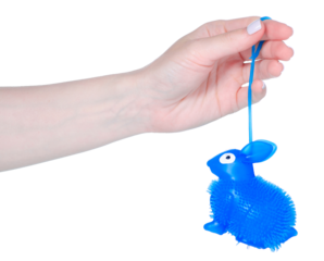 Antistress rubber bunny toy in hand isolation