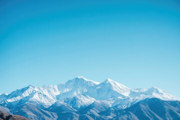 Snow-Capped Mountain Range Under a Clear Blue Sky