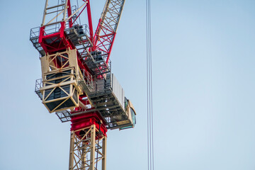 A part of a Big Construction tower crane against a clear blue sky