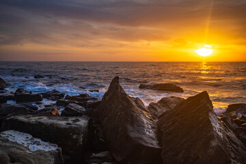 Sunrise over the sea and rocky coast