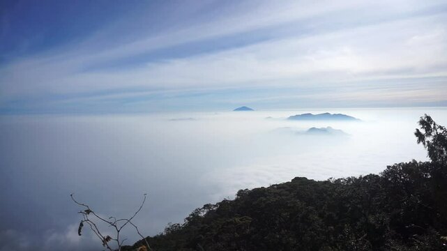 The natural beauty of the bright peak of Mount Cikuray with a stretch of clouds under the blue sky at an altitude of 2821 meters above sea level, Mount Cikuray, Garut, Indonesia