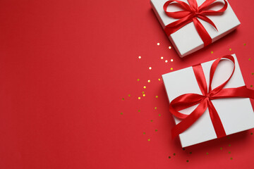 Beautiful gift boxes with confetti on a colored background