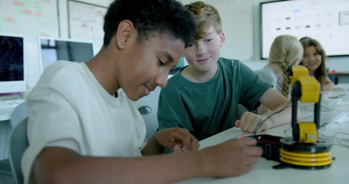 School Children in STEM Computer Classroom, Looking at Robot arm