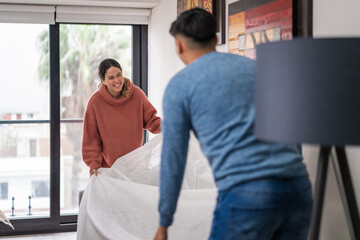 Fototapeta premium Young couple arranging furniture in new apartment