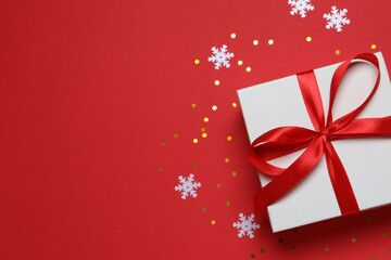 Beautiful gift box with confetti on a colored background