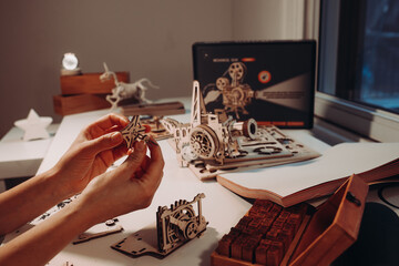 Assembling 3D puzzle in a shape of retro camera. Arts and crafts concept. Home hobby concept. Leisure activity concept 