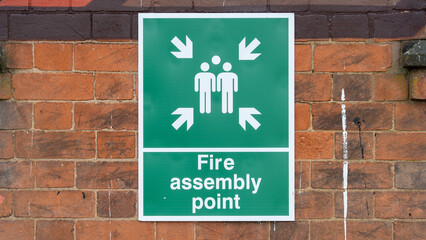 Fire Assembly Point Sign Mounted on a Brick Wall