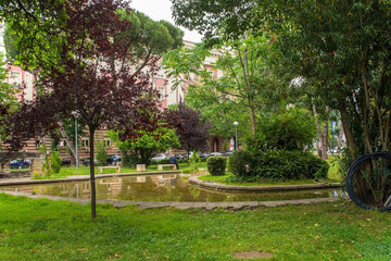 Lulishte Ismail Qemali Park in central Tirana, Albania. Located on the edge of the Blloku area, it's also known as Postblloku Park and is a small green oasis featuring a pond in the middle of this cap