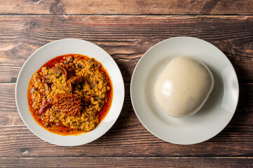 Caption: Tasty Caribbean food served on a white plate or white bowl on a rustic vintage wooden table backdrop - colorful home cooked meals and desserts with chicken, chips, vegetables, rice, bbq, stew