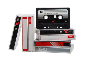 A stack of audio cassettes. Close-up of an audio cassette with a sticker without text.  Cassettes for audio recordings and music. Analog storage medium.