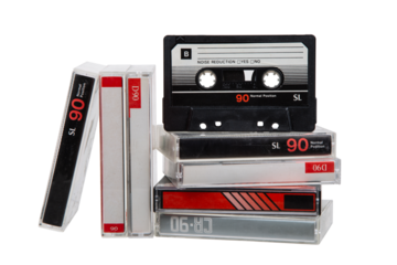 A stack of audio cassettes. Close-up of an audio cassette with a sticker without text.  Cassettes for audio recordings and music. Analog storage medium.