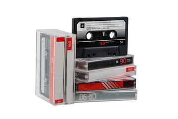 A stack of audio cassettes. Close-up of an audio cassette with a sticker without text.  Cassettes for audio recordings and music. Analog storage medium.