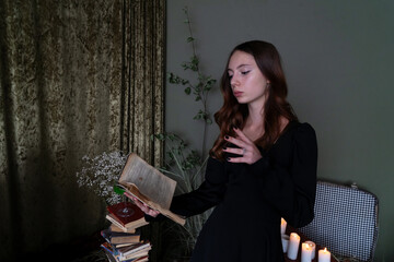 An Enchanting Sorceress is deeply engrossed in reading a Spellbook surrounded by swirling, Mystical...