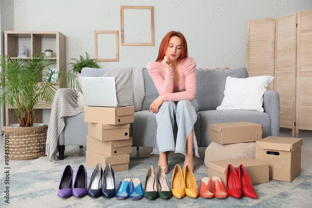 Sticker Young woman choosing new shoes at home