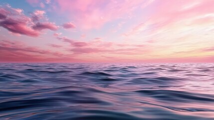 Fototapeta premium A beautiful ocean with a pink sky in the background. The water is calm and the sky is filled with clouds