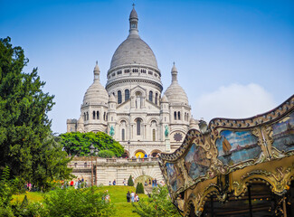 Fragment of colourful carousel with Basilique Du Sacre Coeur de Montmartre. Close up photo of...