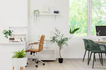Interior of engineer's office with workplace and wind turbine models