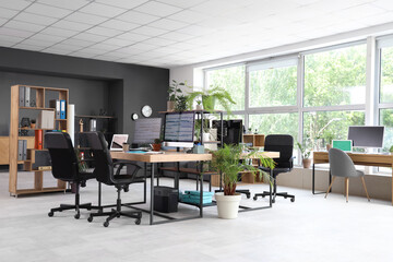 Fototapeta premium Interior of programmer's office with desks and plants