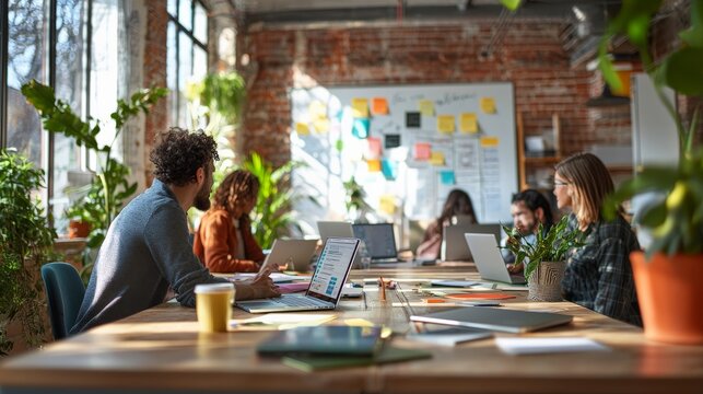 A bright, open office space with a diverse team brainstorming around a whiteboard. - Powered by Adobe