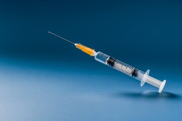 A clean syringe on a plain background, highlighting the importance of vaccines and injections in modern medicine