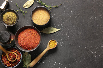 Composition with different fresh spices on dark background