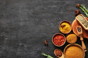 Composition with different fresh spices on dark background