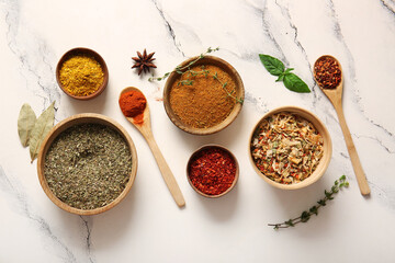 Composition with different fresh spices on light marble background