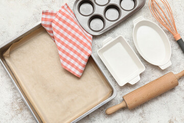 Composition with baking tray for oven and different kitchen utensils on light background
