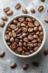 Fototapeta premium Freshly roasted coffee beans in a rustic bowl on a textured surface
