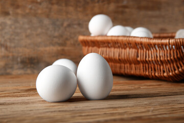 Raw chicken eggs on wooden background