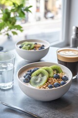 two smoothie bowls with fruit and granola