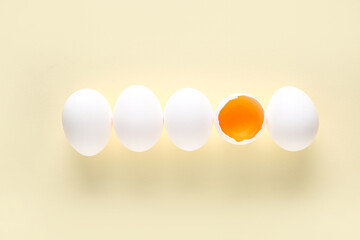 Raw chicken eggs on beige background