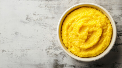 Polenta corn meal dish with copy space, top view of healthy homemade porridge, traditional Italian cornmeal cuisine, gourmet dinner plate, delicious yellow maize food