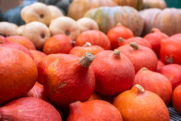 Stack of red pumpkins at a stall at the agricultural products market